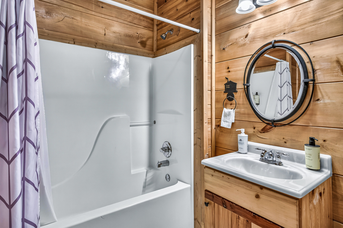 This sparkling clean bathroom blends rustic charm with modern convenience, offering everything you need to feel at home.