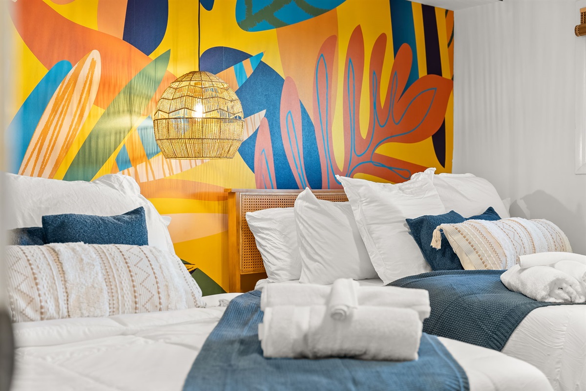 Bright tropical feel accent wall makes for an uplifting retreat