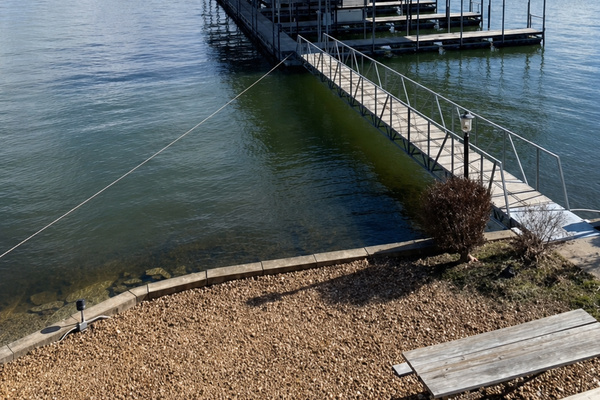 Sandy shoreline beside the waterfront dock