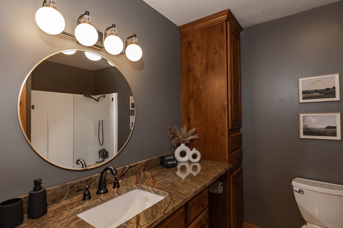 {Bathroom 3} A spacious vanity, oversized mirror, and full tub and shower make this bathroom comfortable and functional for group stays.