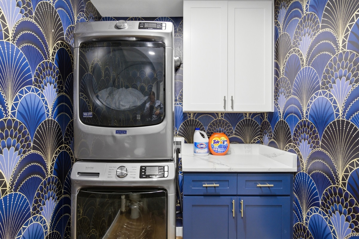 In-home Washer and Dryer with designer art deco wallpaper. Full laundry access included for every stay.