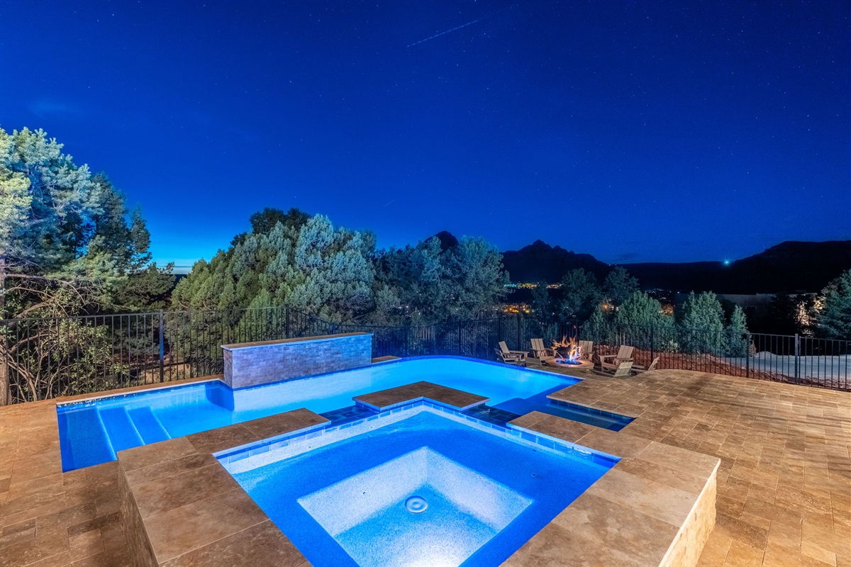 Nighttime oasis—soak in the hot tub #1 under the stars with glowing poolside views.
