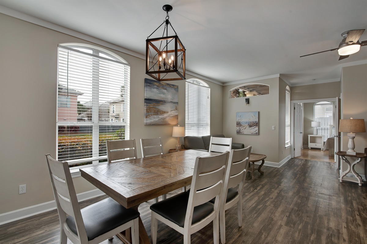 Formal dining area with farmhouse‑style table and chandelier