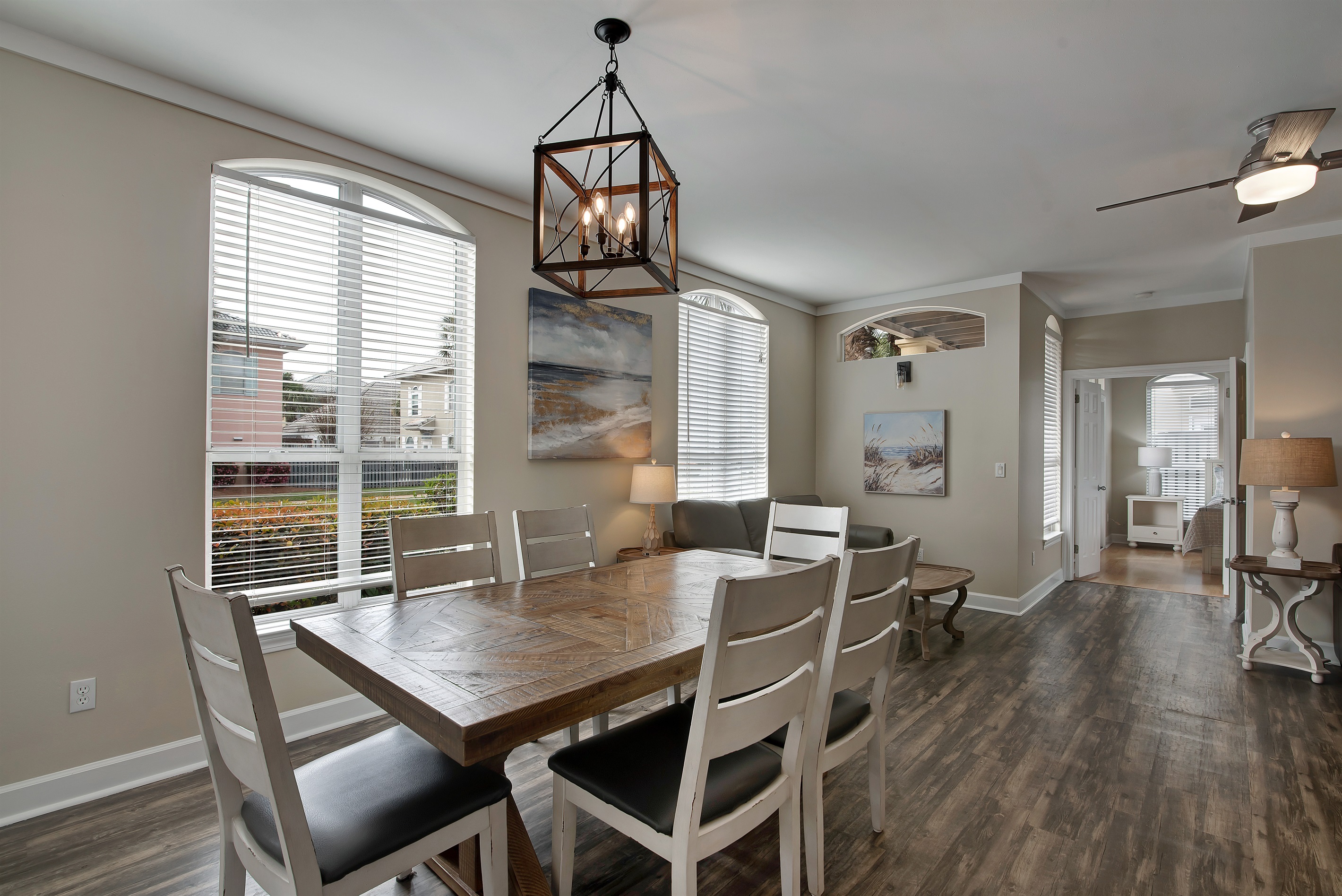 Formal dining area with farmhouse‑style table and chandelier