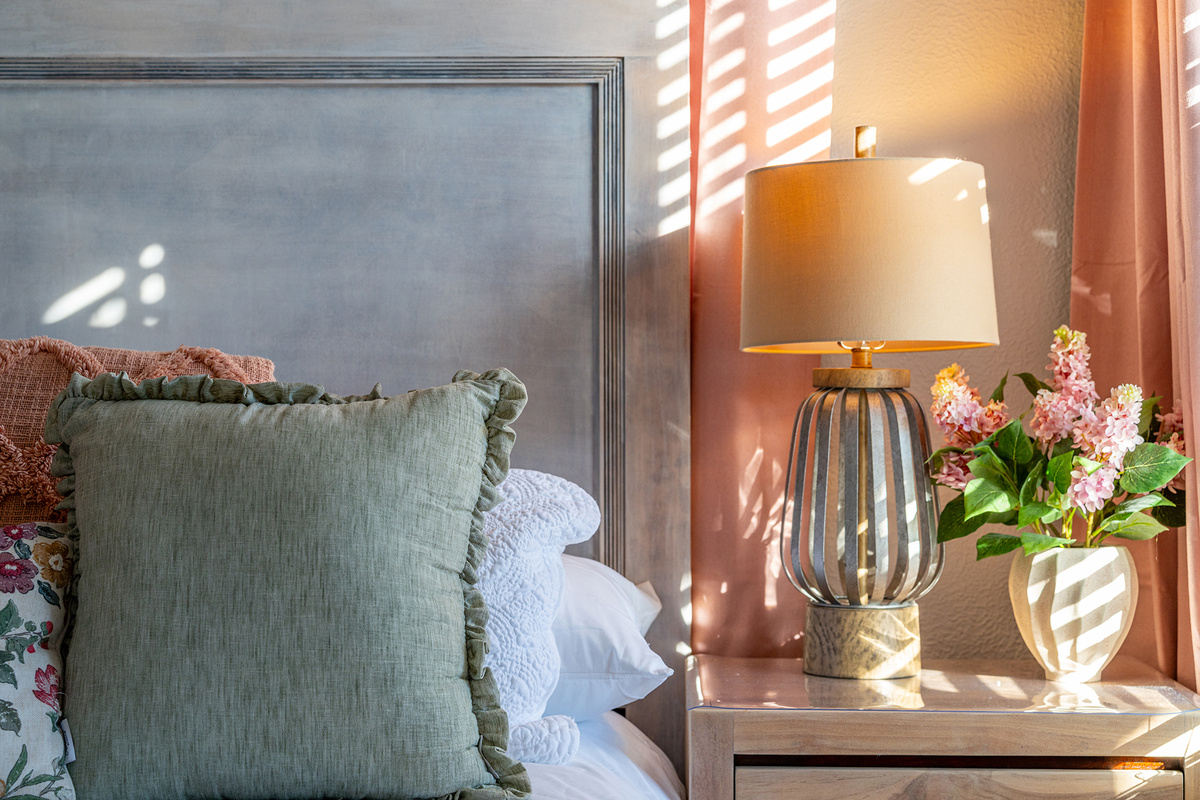 Cozy bedding, warm lighting, and inviting spaces throughout.