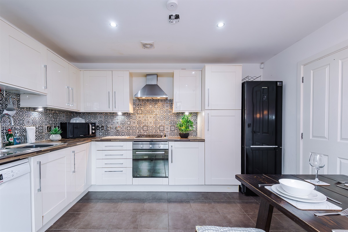 The bright and spacious kitchen benefits from a washer/dryer, dishwasher, microwave, hob, oven and fridge freezer