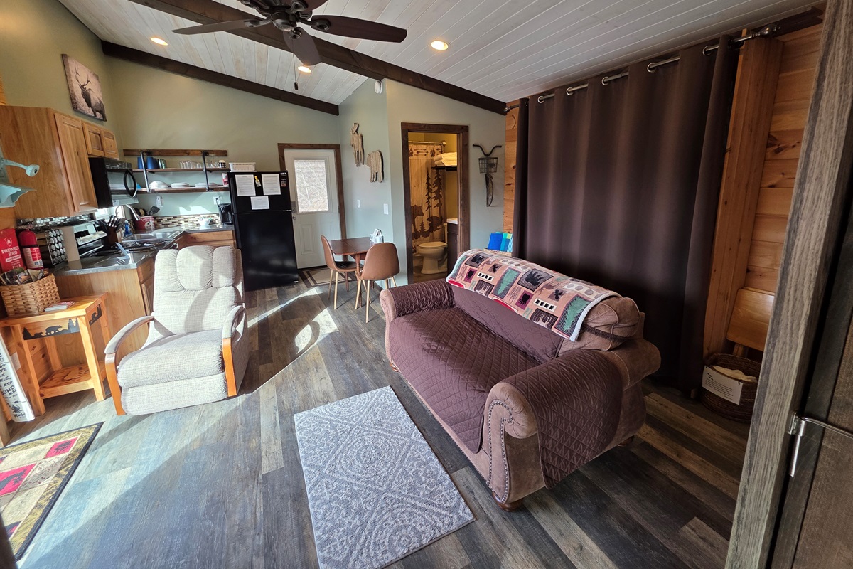 Queen size murphy bed behind the brown curtain. And yes, it is a REAL mattress. No bars in your back!