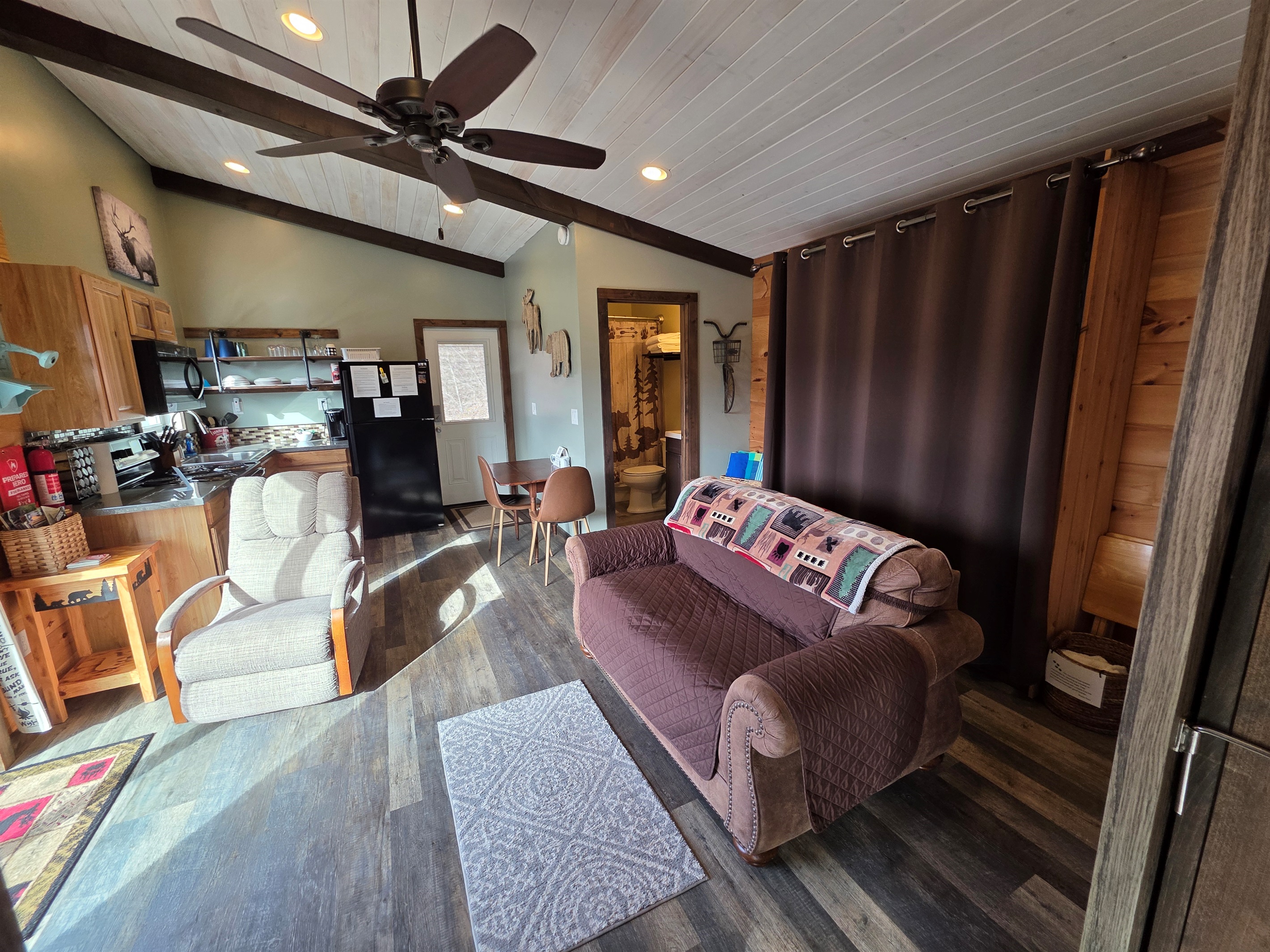 Queen size murphy bed behind the brown curtain. And yes, it is a REAL mattress. No bars in your back!