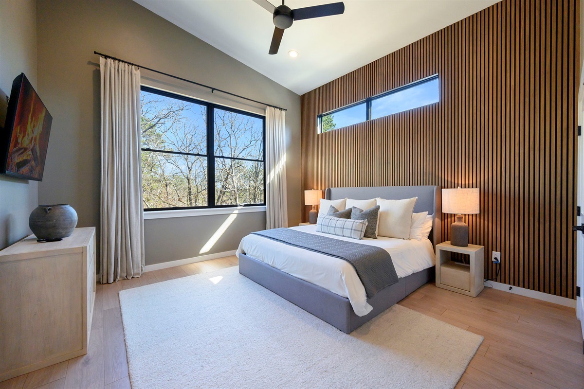 King Suite 2 - Large and spacious suite with teak wood paneling, designer finishes, smart TV, premium king mattress, and luxury bedding. Includes stunning views of the hardwood forest. 