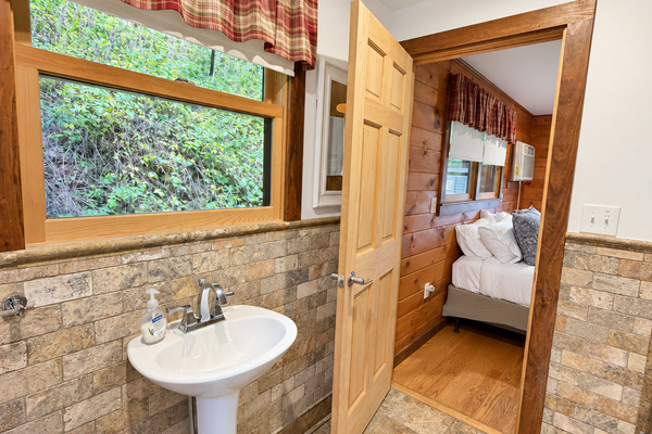 Bathroom with wide tiled shower and frame-less glass surround