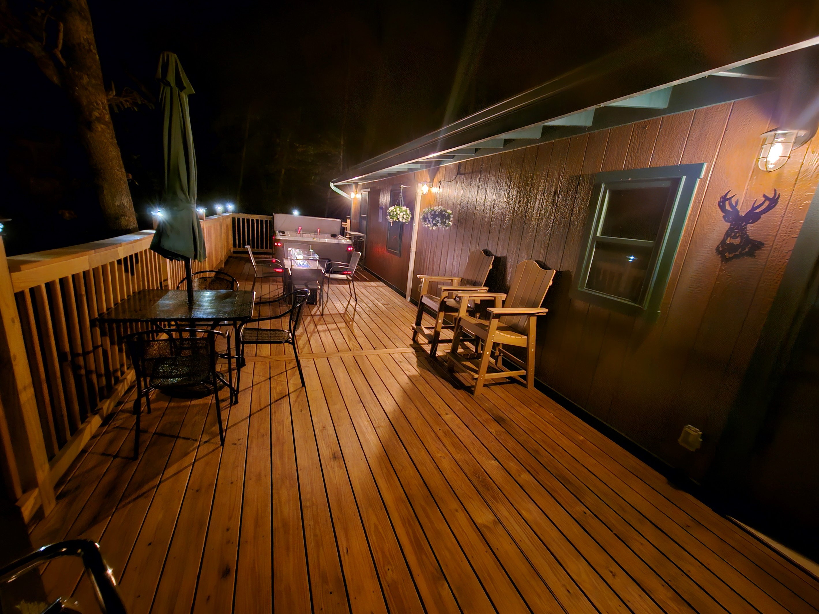 End the evening on the deck — fire glowing, lights twinkling, and the forest all around you.