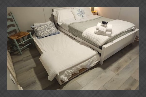 bedroom 2 with full size bed and twin bed with flat screen tv.