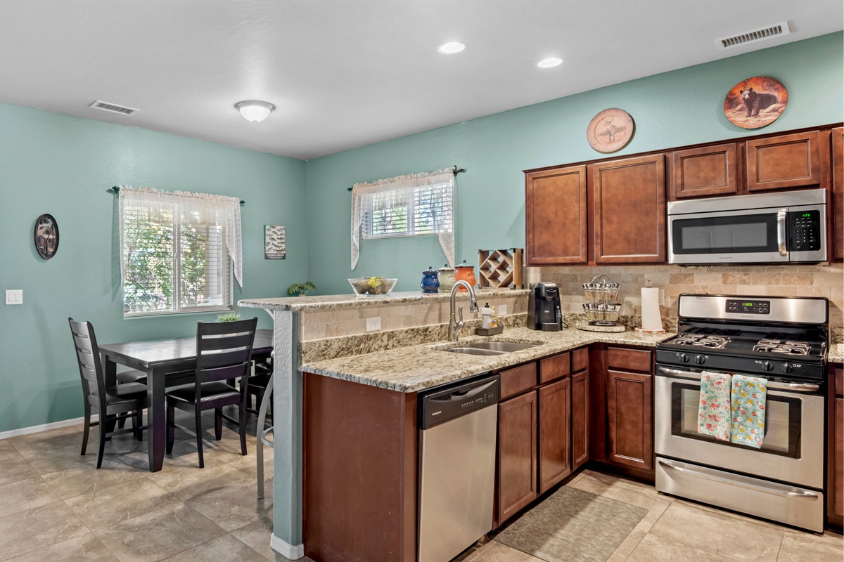 Functional kitchen with a breakfast bar for four, seamlessly connecting to the dining space for convenience.