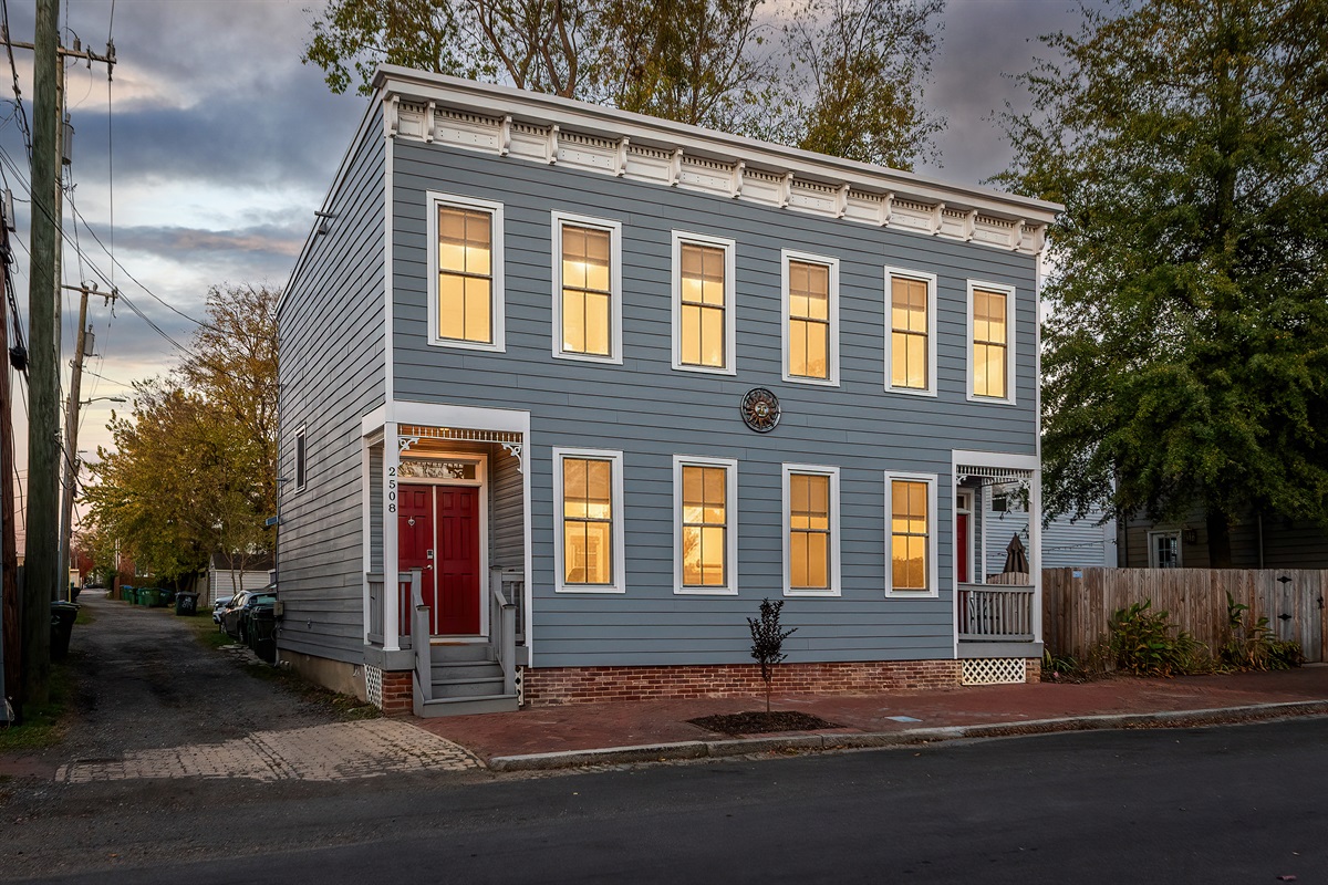 Exterior Escape: Beautifully restored gem with inviting windows and vibrant red door!
