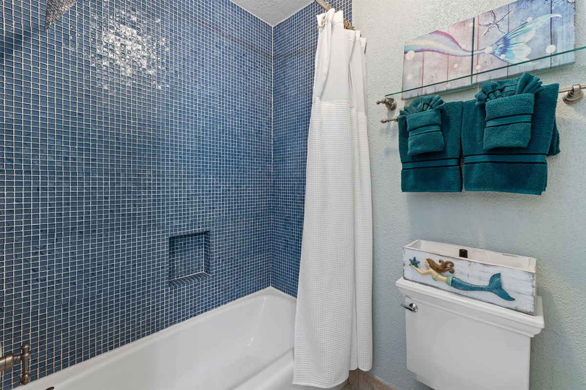 The primary bathroom provides additional comfort with a fresh and clean design, including a bathtub which is great for those traveling with kids.
