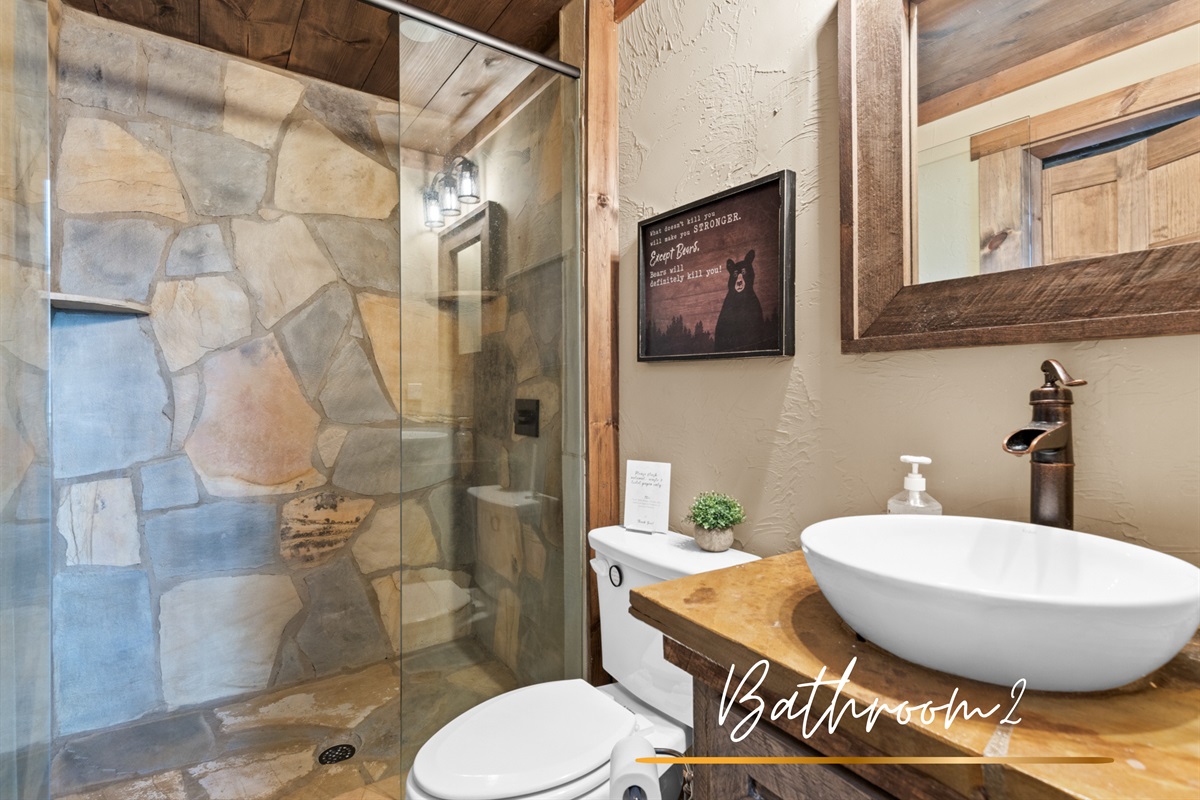 Bathroom 2: is styled with rustic elegance, featuring a walk-in shower and ample counter space.