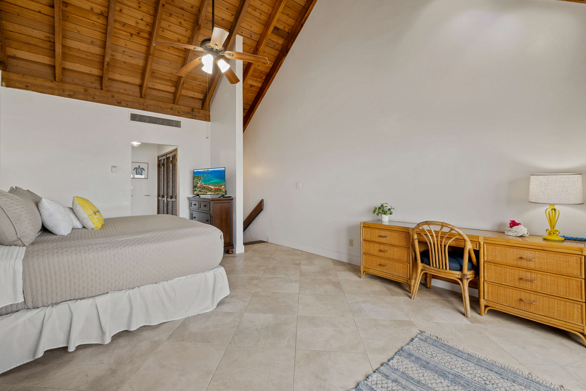 Comfortable king bedroom with plenty of natural light and coastal charm.