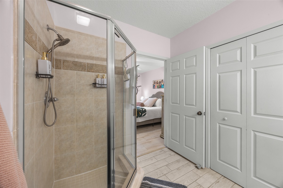 Step into a fresh and modern ensuite with a glass walk in shower.