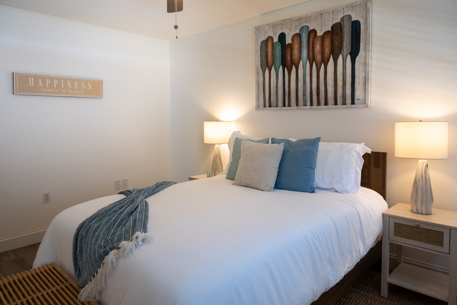 Bedroom 1: plush queen bed under the oars – happiness is a beach day