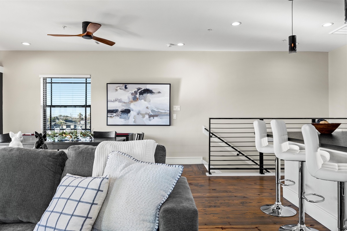 Living Room: Bright and airy space with chic decor, perfect for relaxing after beach adventures!