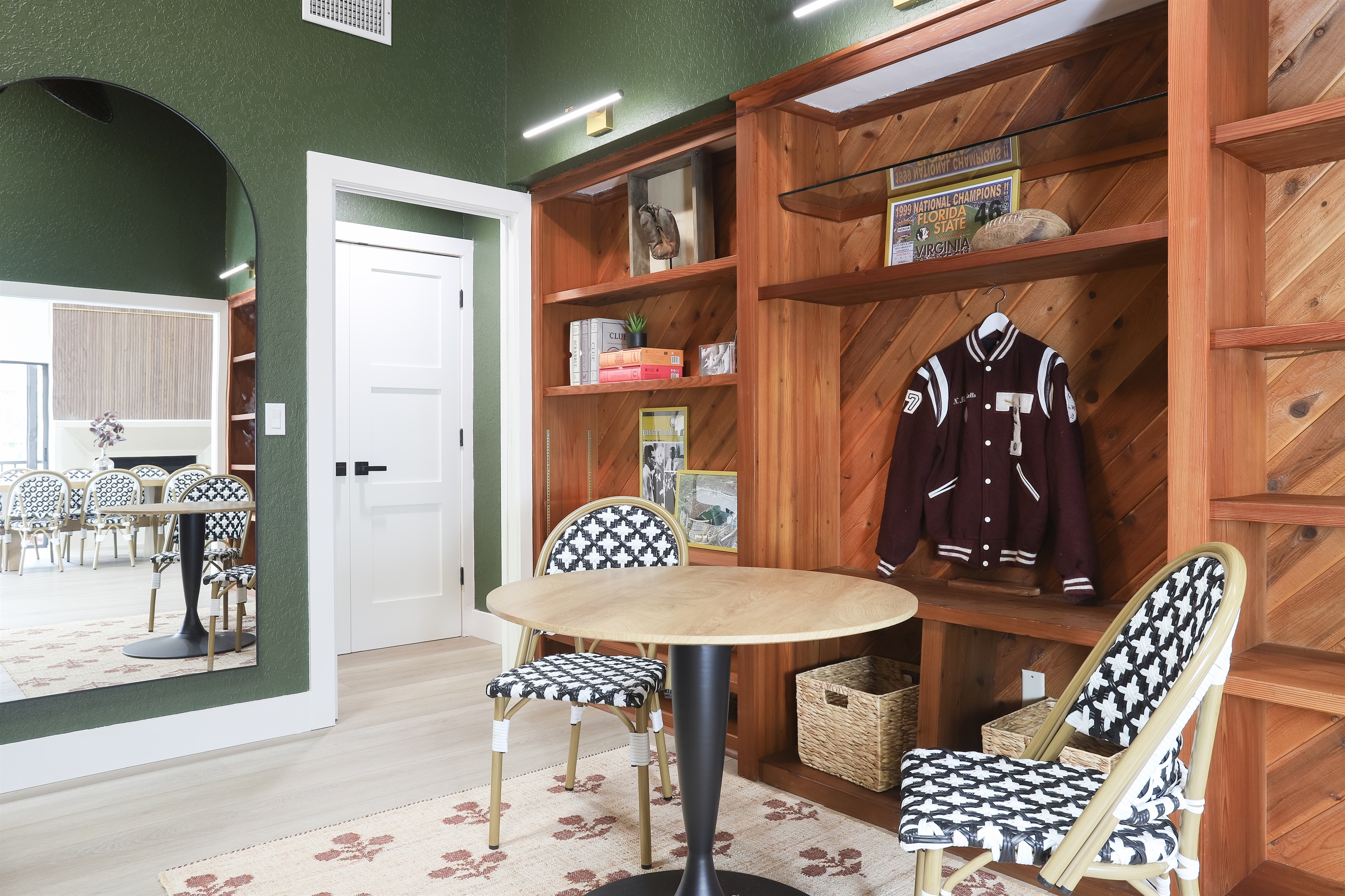 This isn’t your average living room—it’s equal parts vintage varsity and movie-night mood lighting. Think high school trophy case meets curated comfort, with a 65" Smart TV, sound bar and all the nostalgic energy and board games.