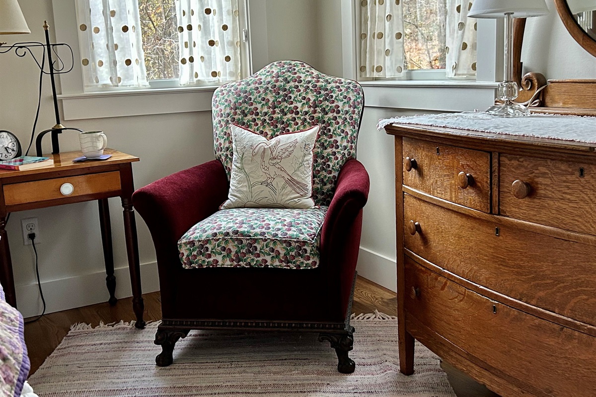 Cozy lounge chair creates lovely reading spot in the main bedroom. Great light!