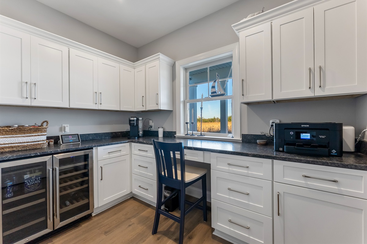 Dedicated Office Space With Coffee Maker and Additional Beverage Fridge Overlooking Pool