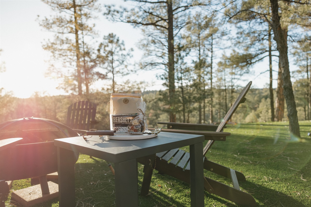 Golden hour at Poppywood Pines invites s'mores around the fire pit surrounded by towering ponderosa pines. This pet-friendly Show Low cabin offers the perfect outdoor space for family gatherings after exploring White Mountains hiking trails and fishing lak