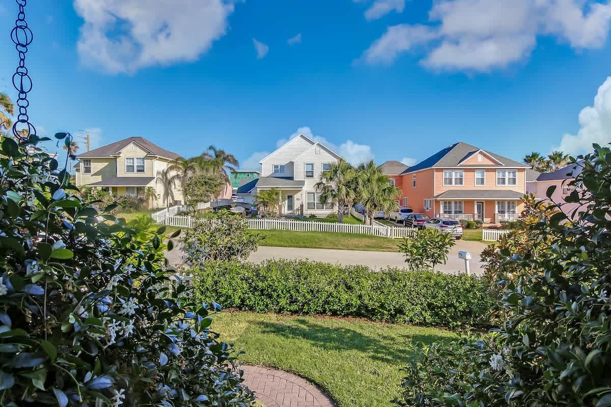 The street outside, quiet and green and thoroughly residential. A few blocks brings you to the boat ramp, and three minutes on foot puts you on the sand. It is a very easy place indeed to spend a week.