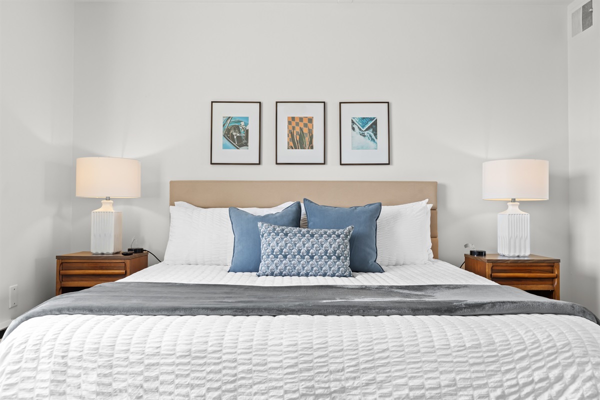 Unwind in style with a plush king bed and a contemporary wood wall that adds warmth and character to the space.