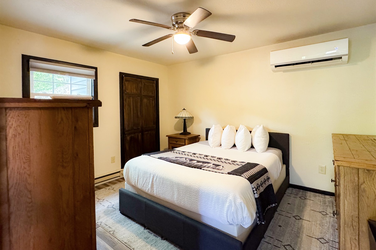 The apartment bedroom has a queen size bed, its own living space and bathroom