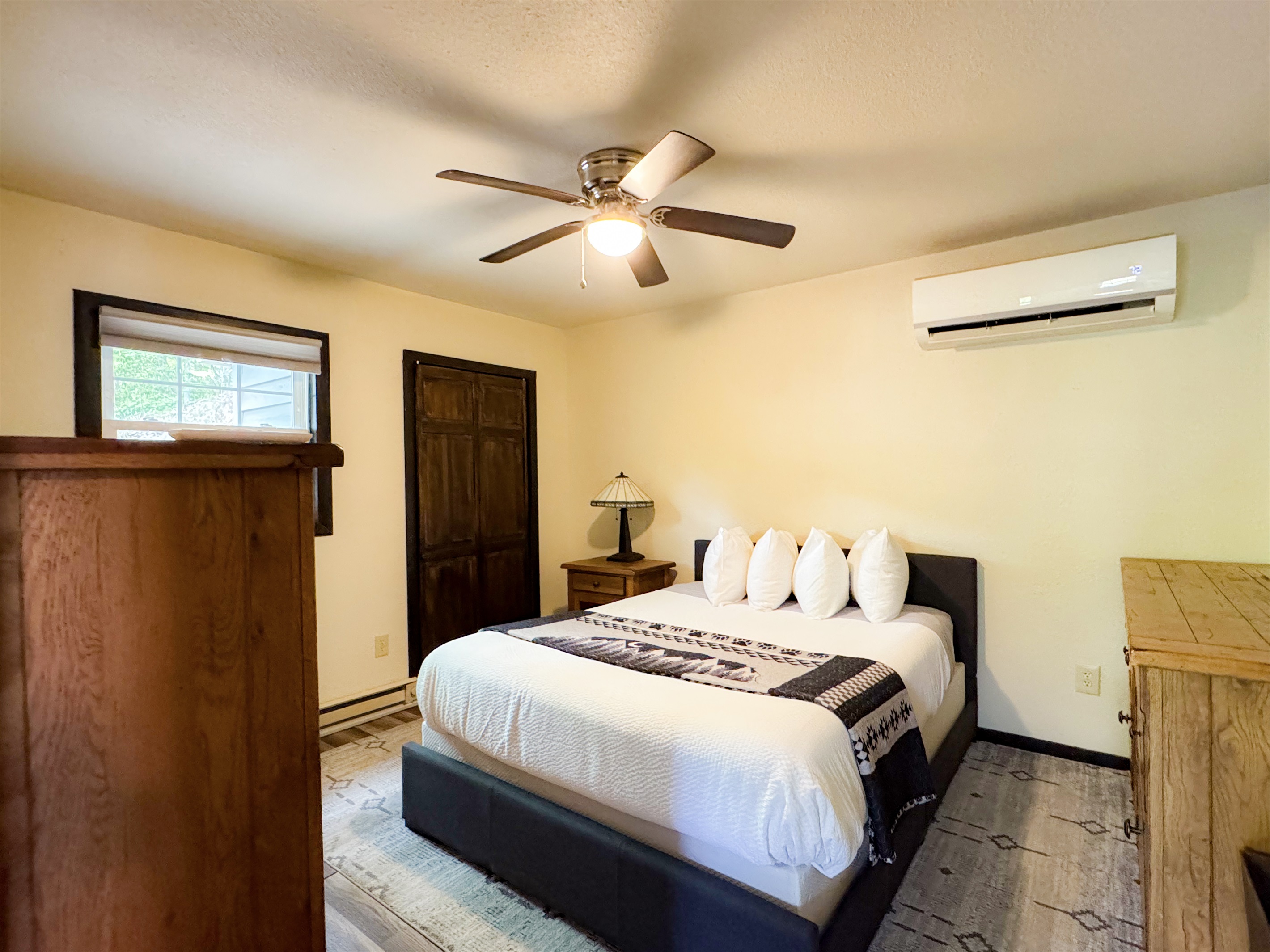 The apartment bedroom has a queen size bed, its own living space and bathroom