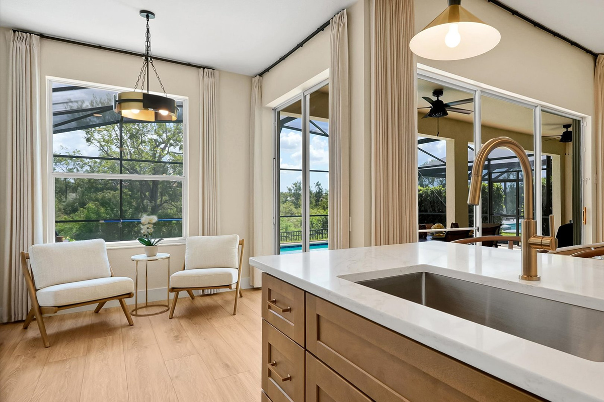 Kitchen: Oversized island with a deep sink, pool views and an adjoining sitting area.