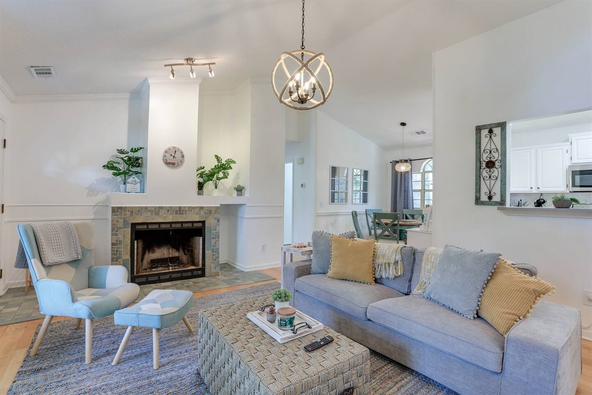 The living room at Pointe North Oasis is bright and airy, with large open windows that let in plenty of natural light, high ceilings that create a spacious feel, and a smart TV for your entertainment needs.