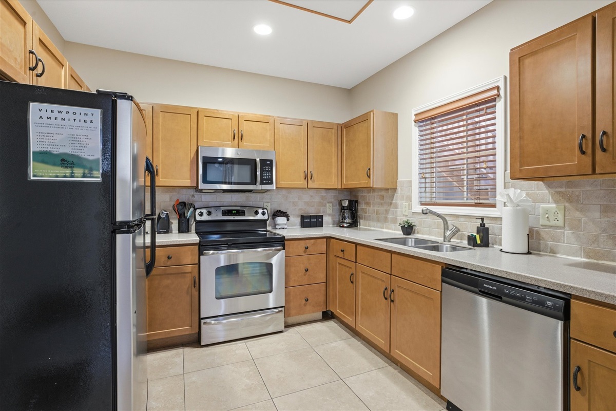 Cook, snack, or gather with your group in unit 312's fully equipped kitchen, stocked with everything you need and open to the main living space for easy connection.