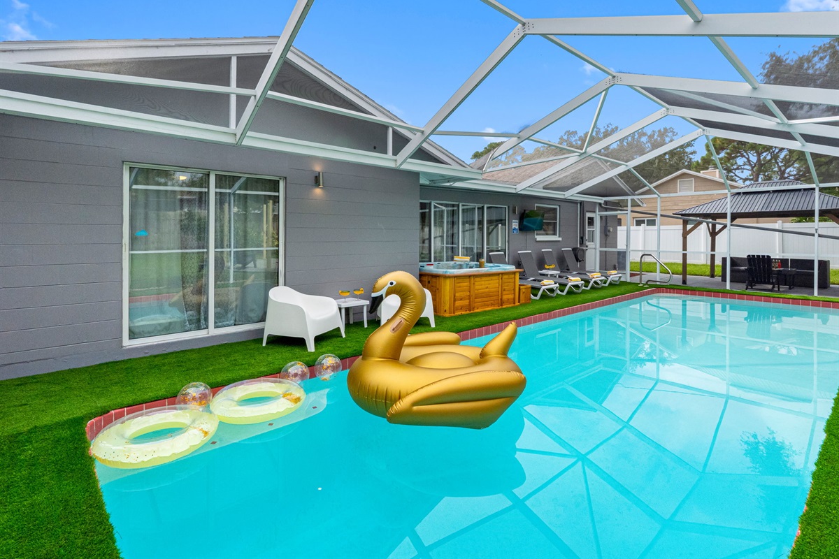 This vibrant pool area is the perfect spot for family fun or quiet relaxation, complete with floaties and streaming-ready TV.