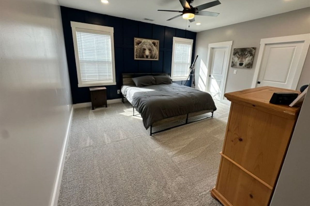 Large bedroom with private sink and shared access to private shower/toilet rooms with bedroom #2. Quaint under stair nook on opposite wall.