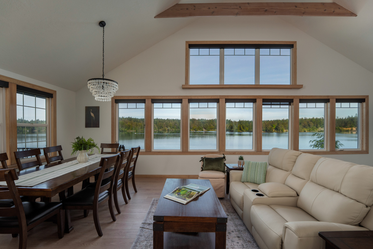 Golden-hour lake views fill the open living and dining space, creating a warm, peaceful setting for shared meals, relaxed conversations, and unforgettable evenings together.