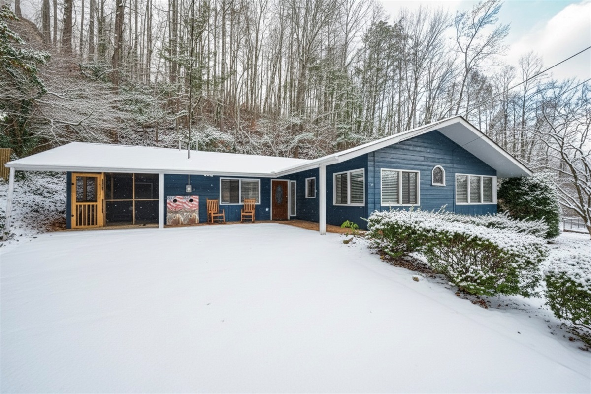 Charming winter cabin nestled in the mountains, showcasing a fresh blanket of snow,. Ideal for guests seeking relaxation, nature, and a cozy retreat. Features a welcoming front porch, forest backdrop, and quiet surroundings perfect for a seasonal escape.