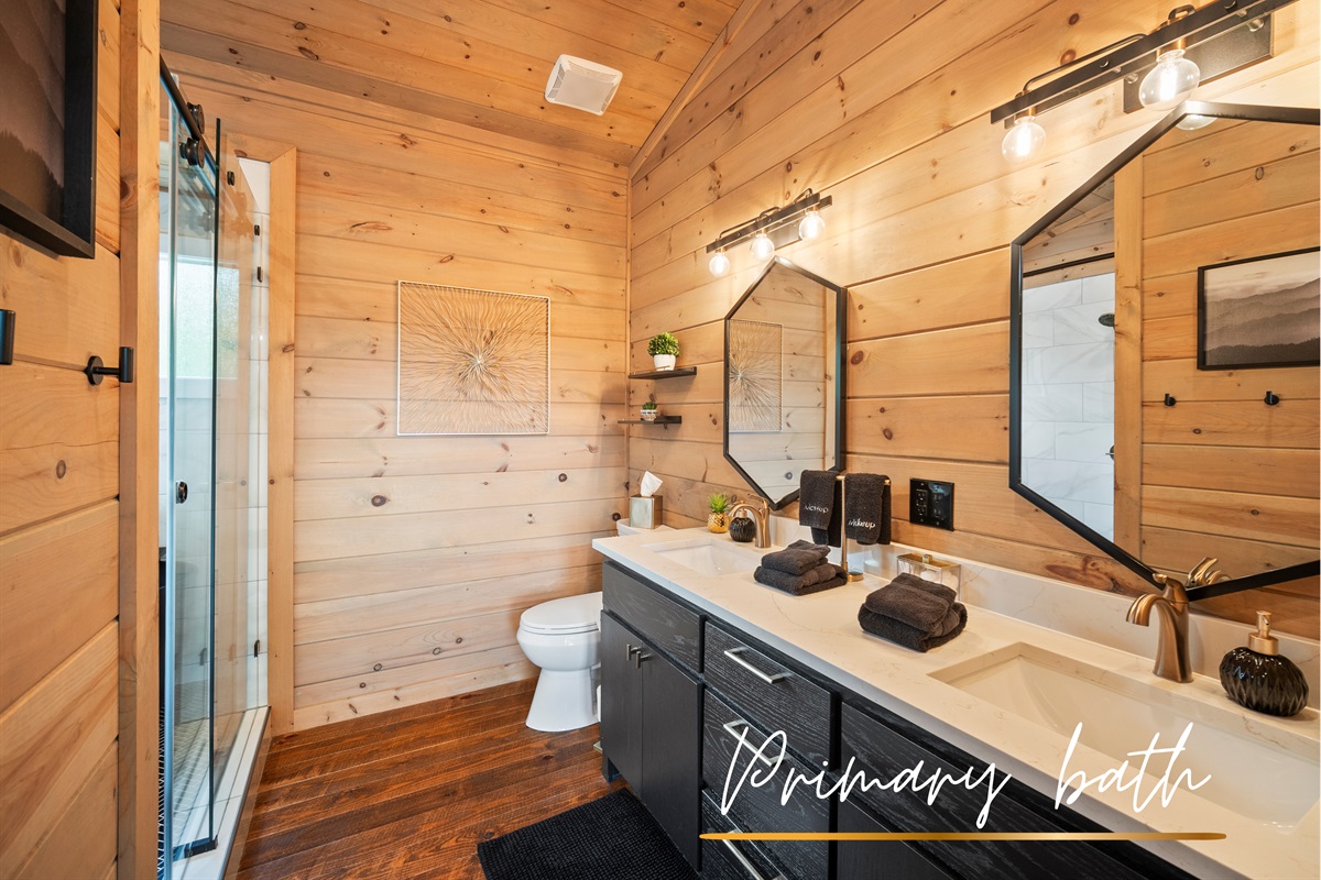 A double vanity with elegant fixtures provides ample space for getting ready in this beautifully designed bathroom.