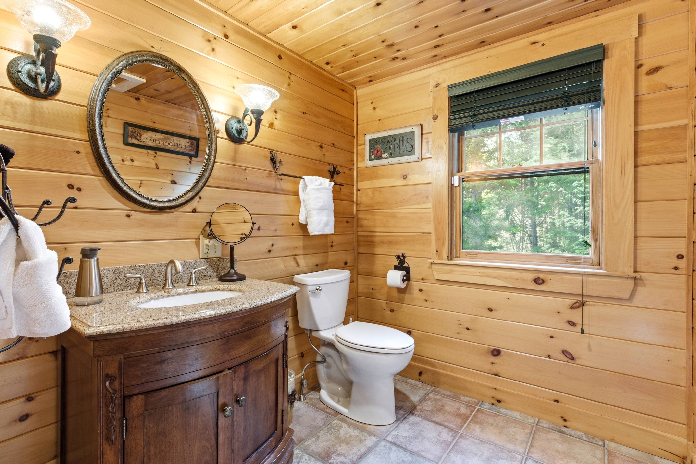 Rustic meets modern in this full bathroom, complete with charming wood finishes and ample space to refresh.