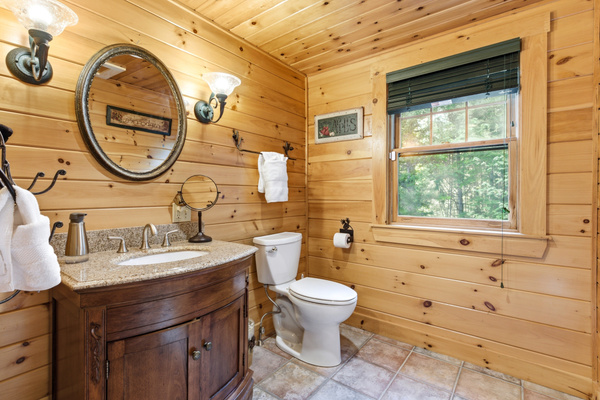 Rustic meets modern in this full bathroom, complete with charming wood finishes and ample space to refresh.