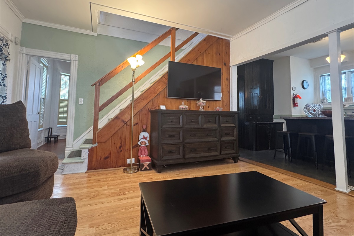Comfy living room with large SmartTV and stairs to 2nd floor
