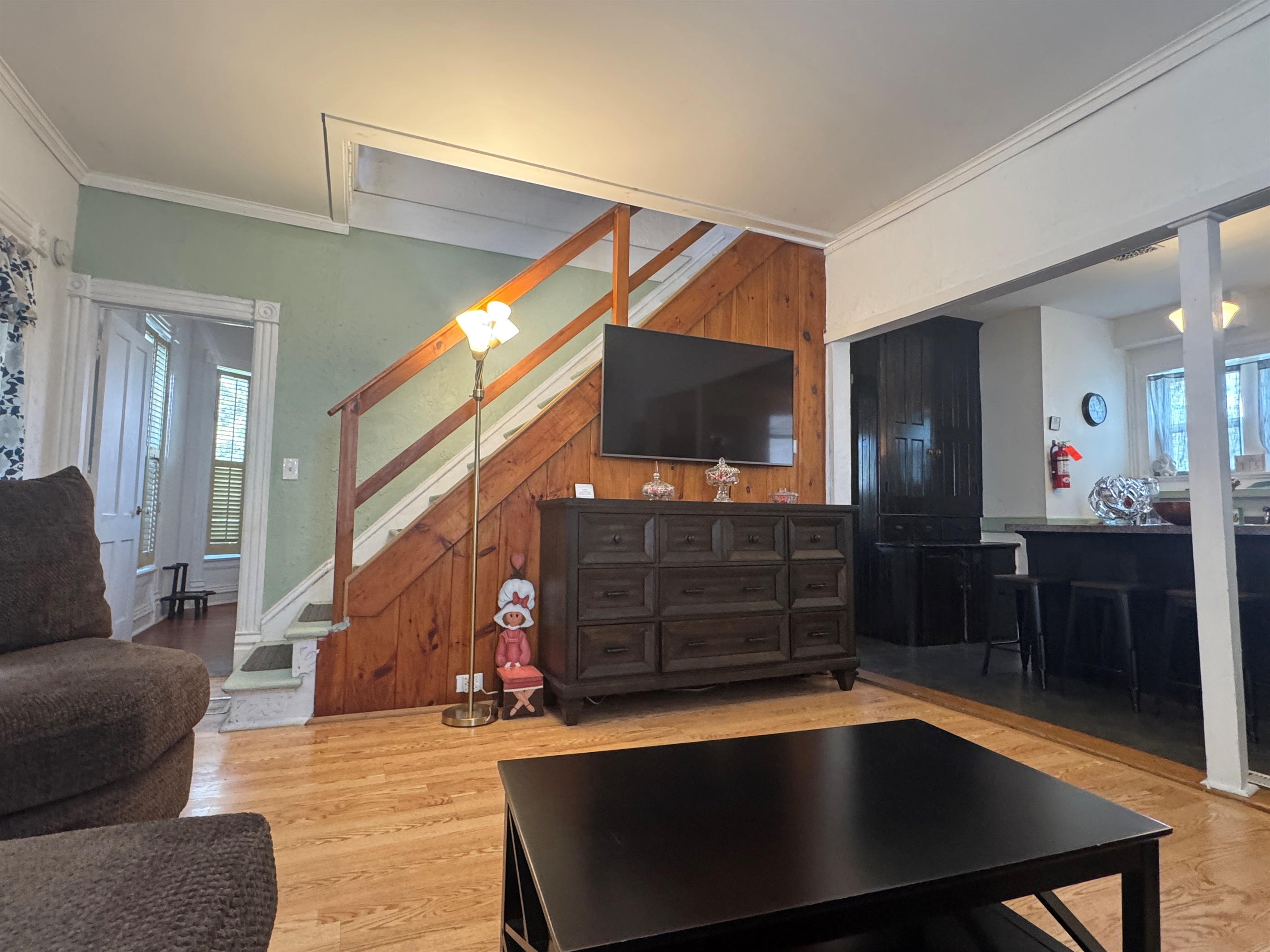 Comfy living room with large SmartTV and stairs to 2nd floor