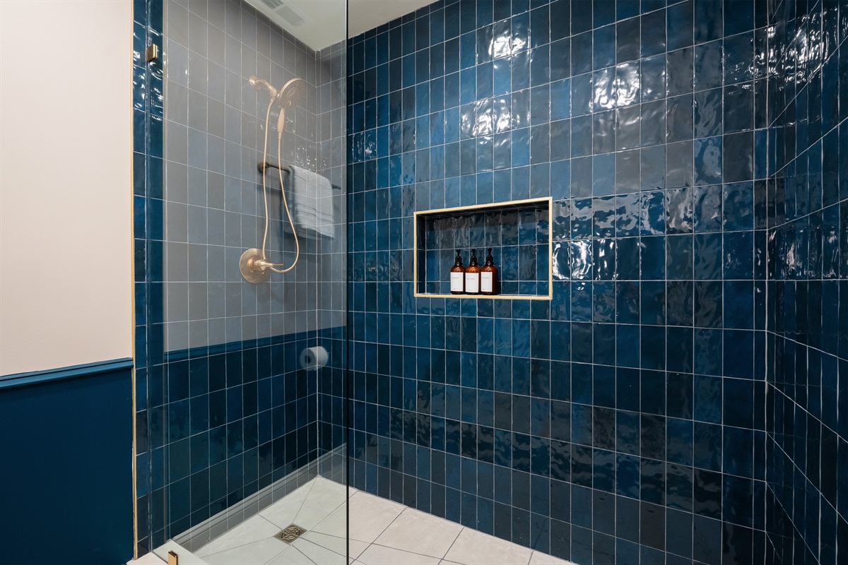 Walk-in shower with tiled finish and built-in shelving - clean, modern, and easy to use