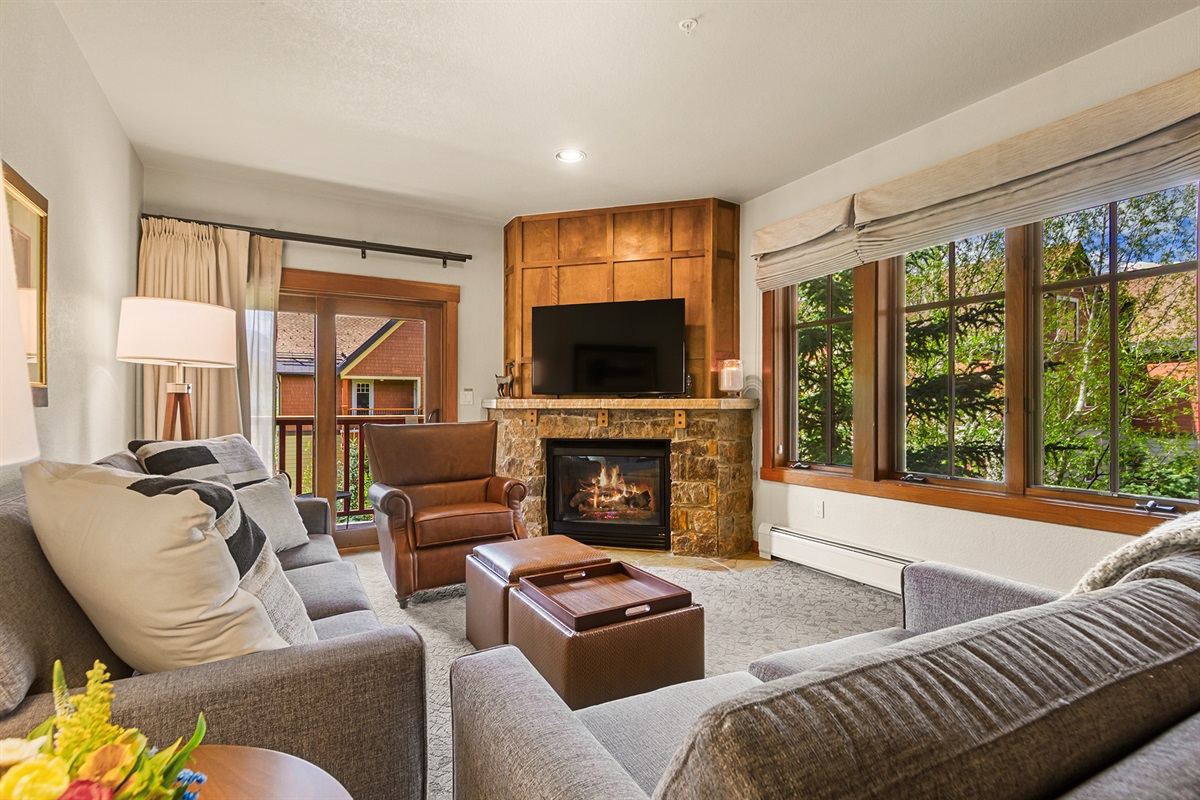 Living room with gas fireplace and deck