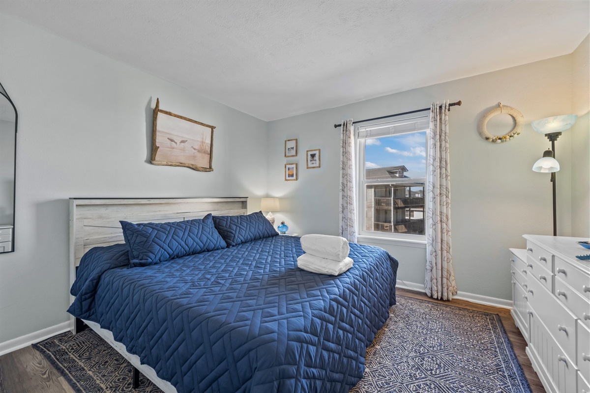 Rest easy in the king suite with soft linens, calming tones, and a bright, airy feel
