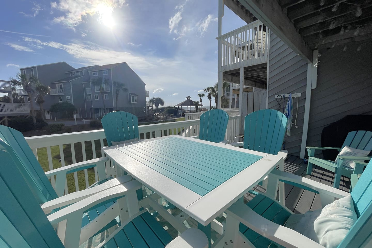 Sit down to a proper breakfast at your dining table. Your whole group fits at once, right off the kitchen, Gulf light coming through.