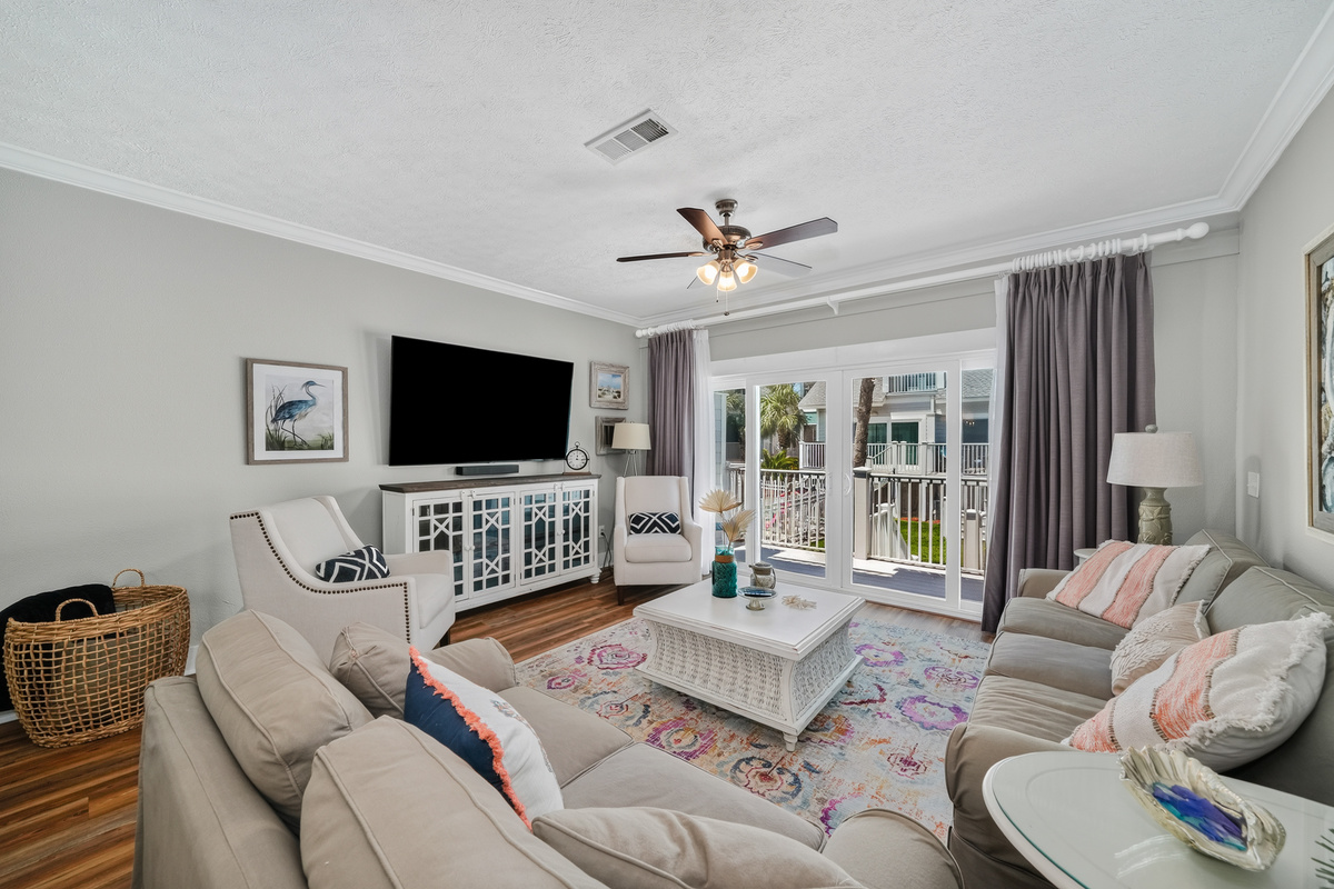 Spacious living room with Smart TV, comfortable seating, and an open-concept layout.