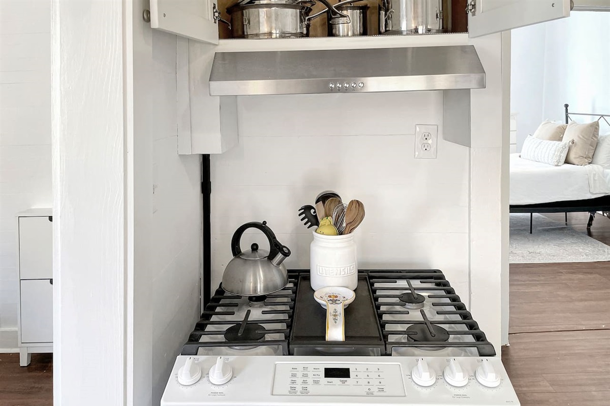Gas stovetop with all the pots and pans to cook up a meal.